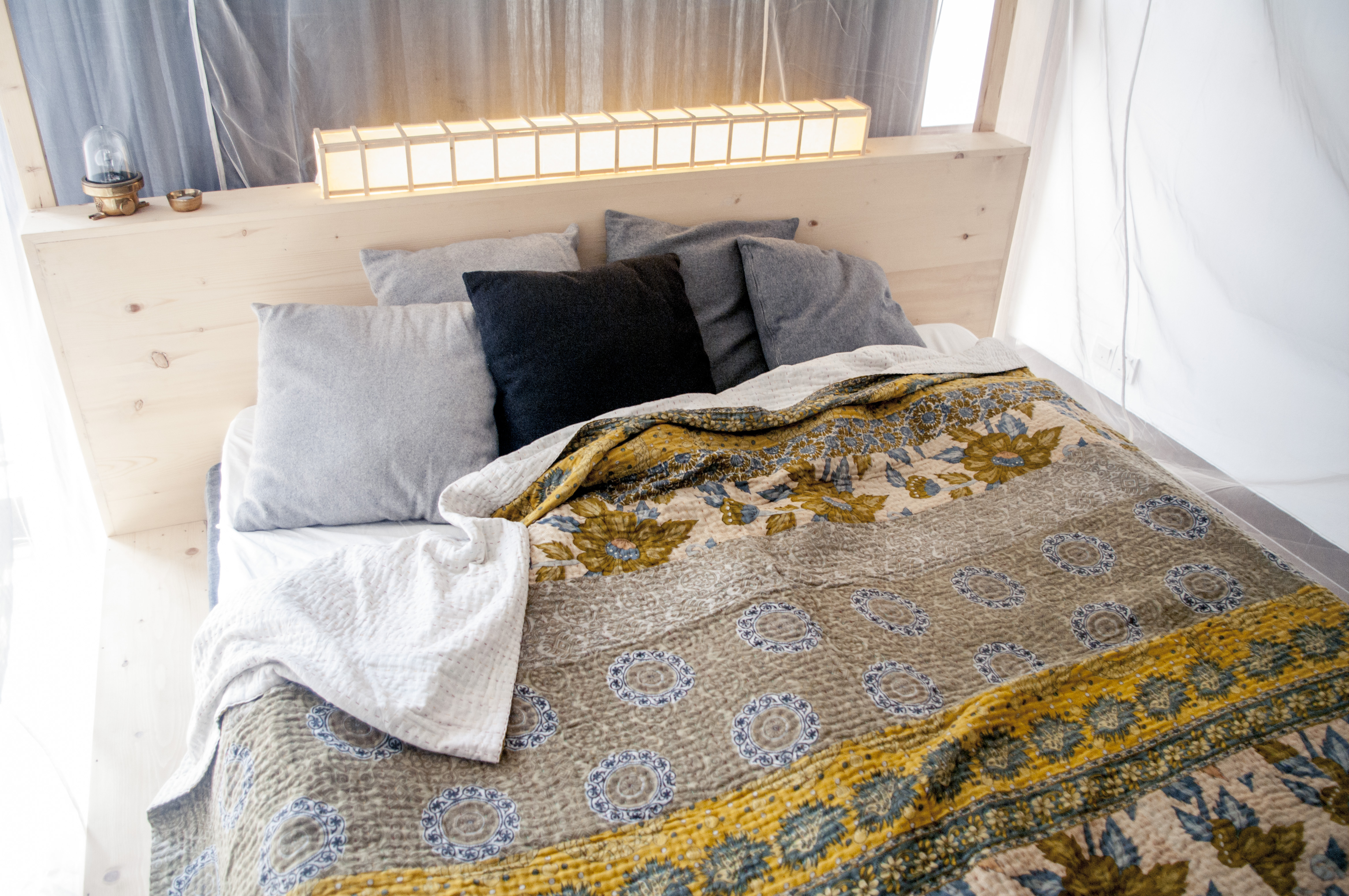 Colorful Kantha sewn bedspread on a king sized bed