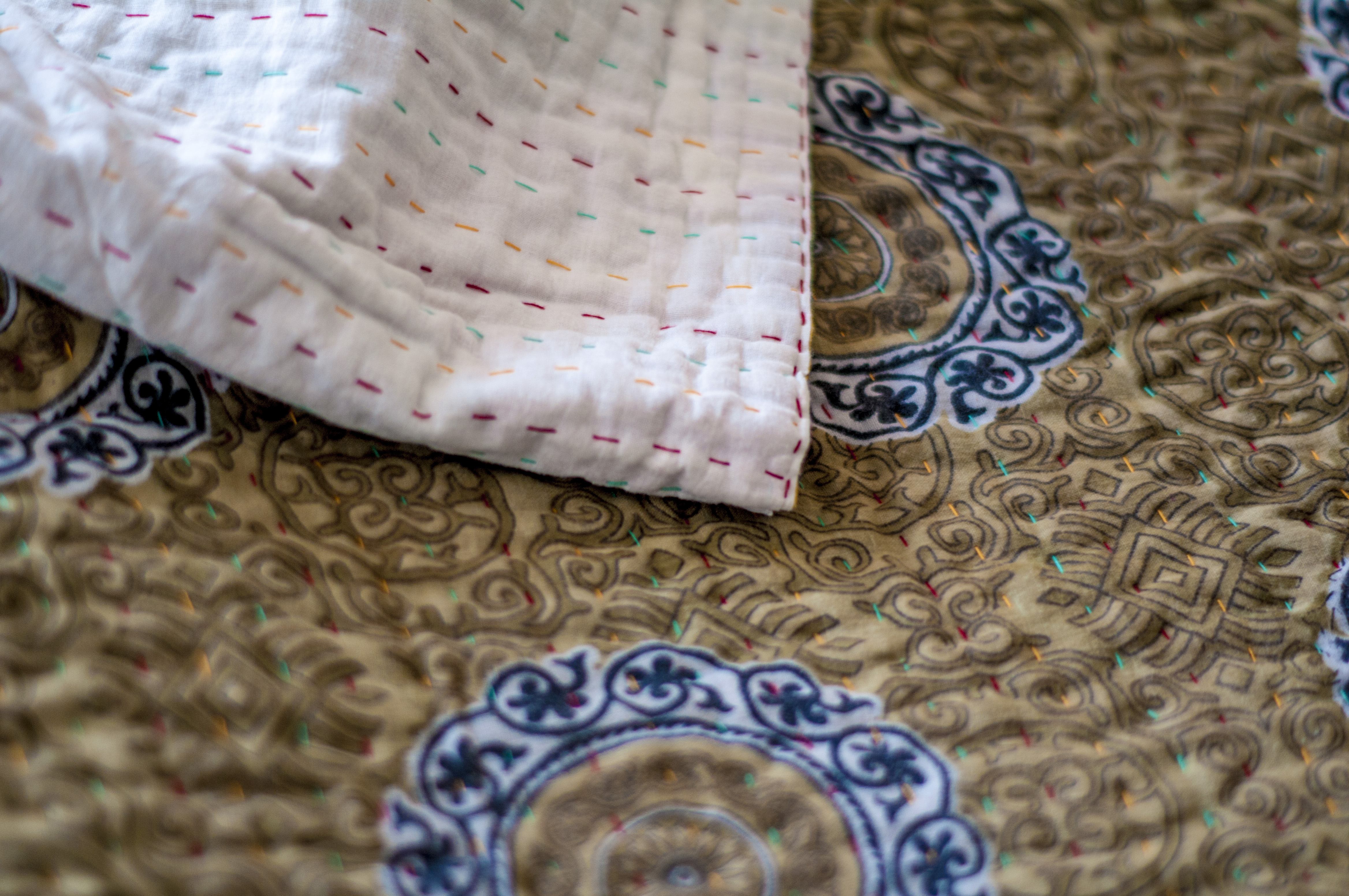 Detail of the fine stiching on a colorful Kantha sewn bedspread