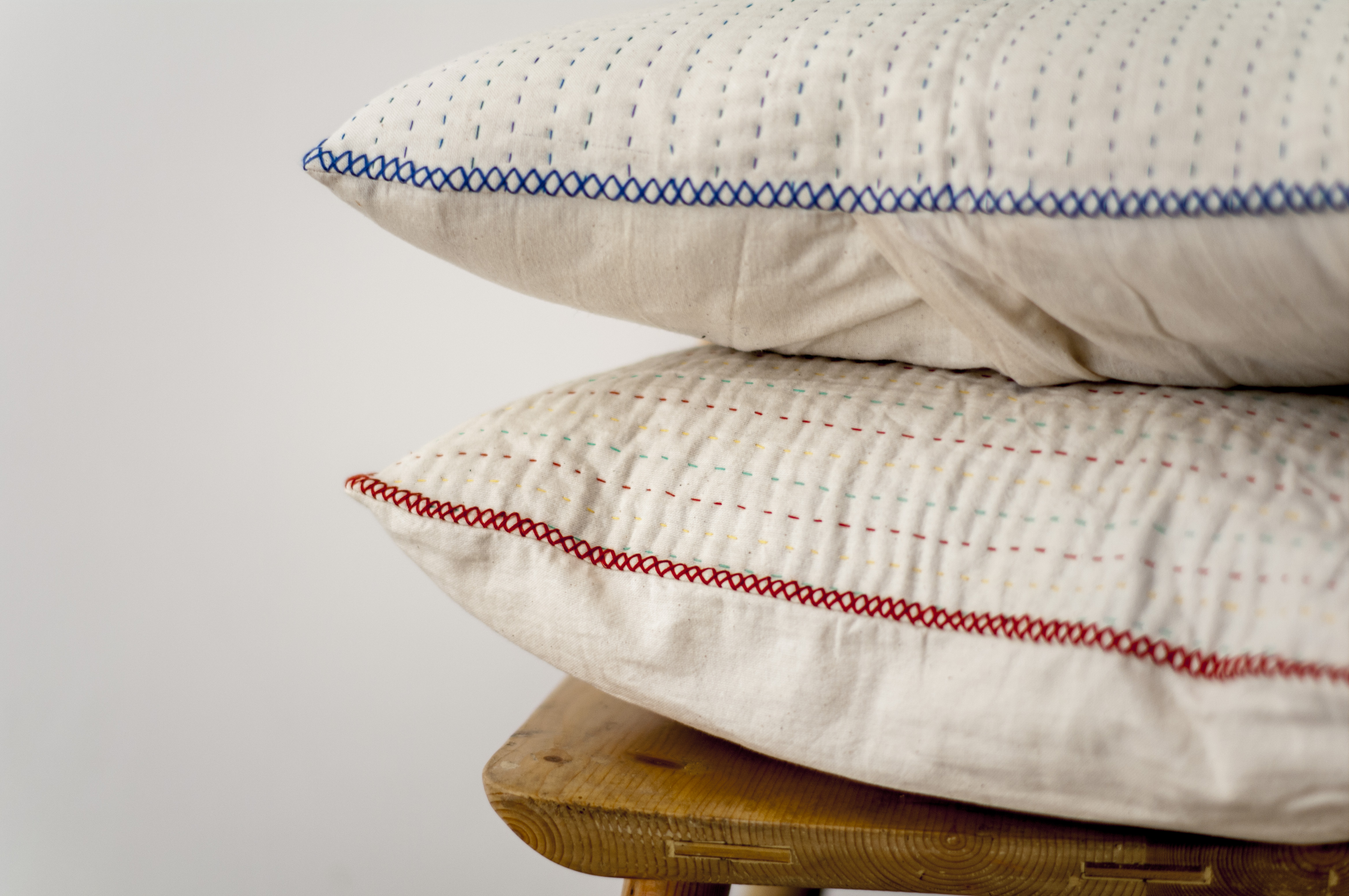 Your choice of red or blue kantha stitching on these natural cotton fabric cushions